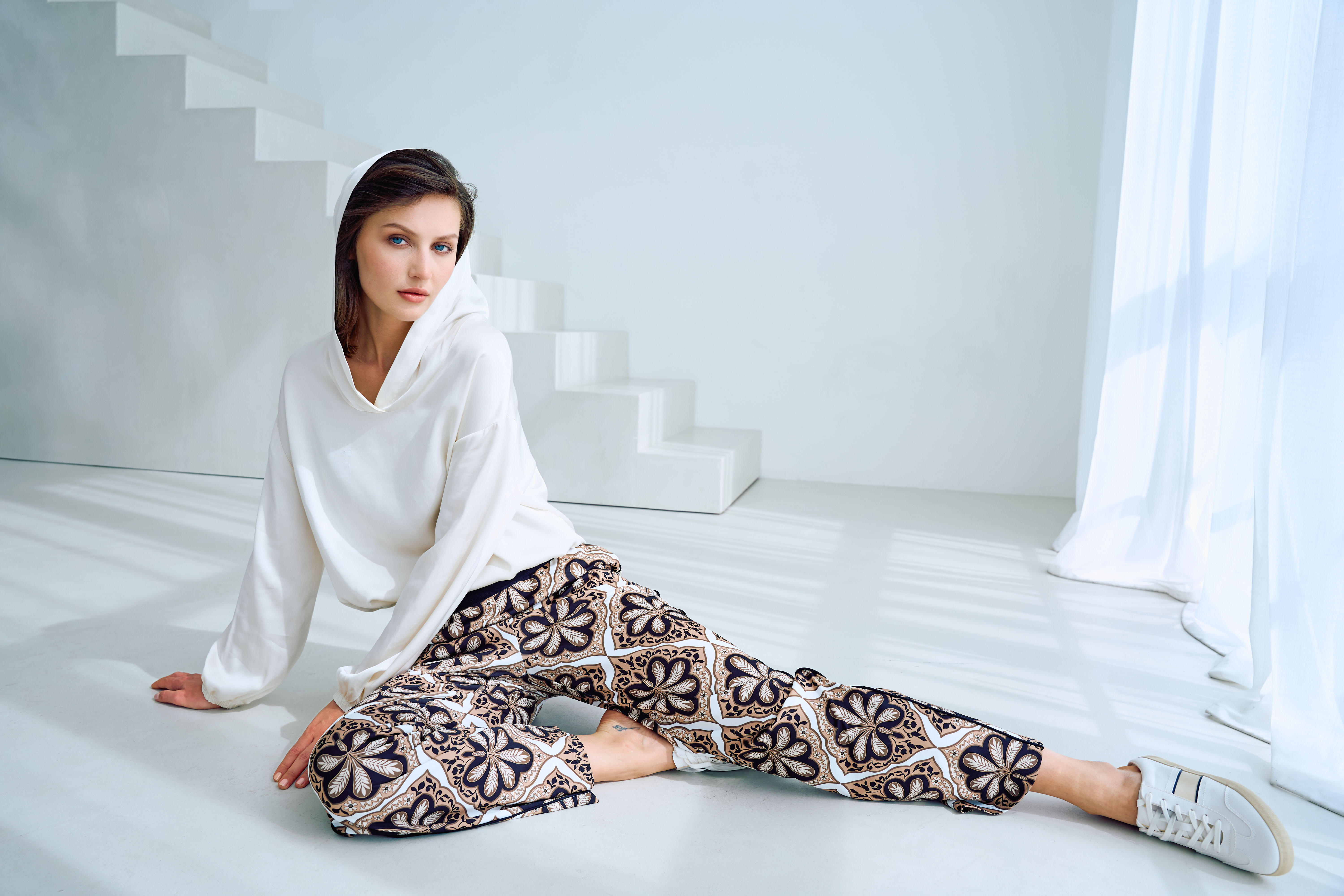 weiße hoodie, leggings, gemustertes pants, Sneaker, Studio-Umgebung