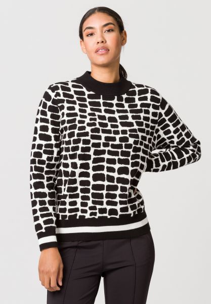 Strickpullover mit plakativem Allovermuster und Streifenbündchen